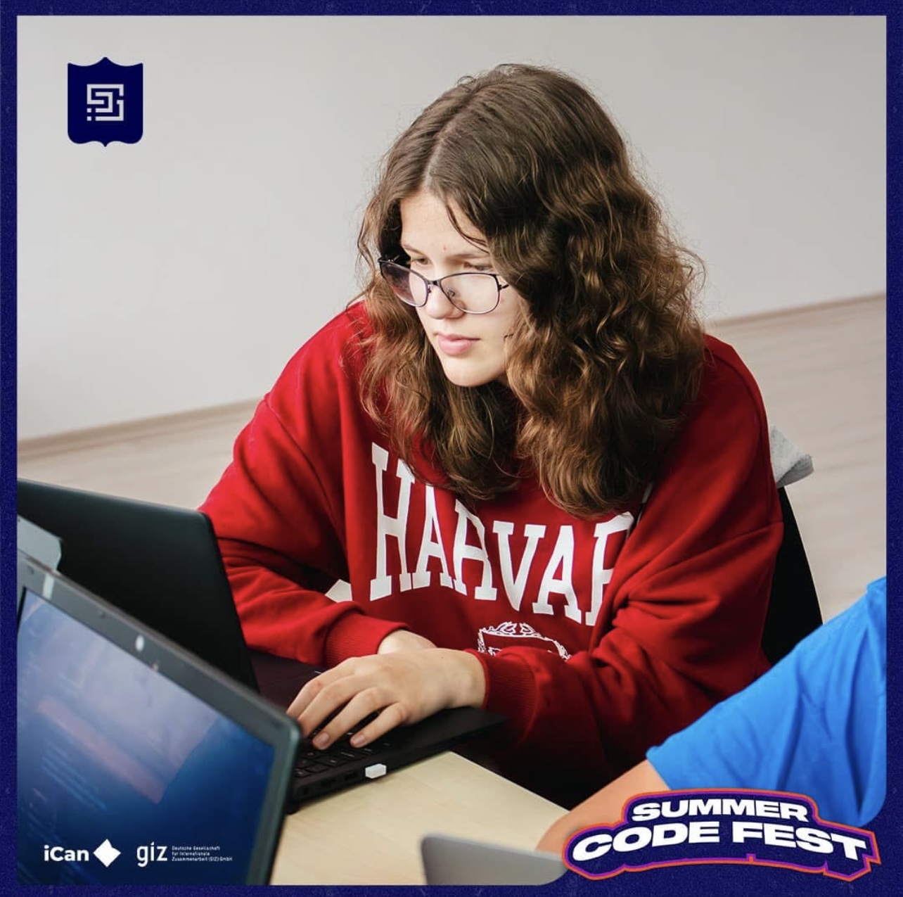 Aurora Dika working on a laptop at Summer Code Fest